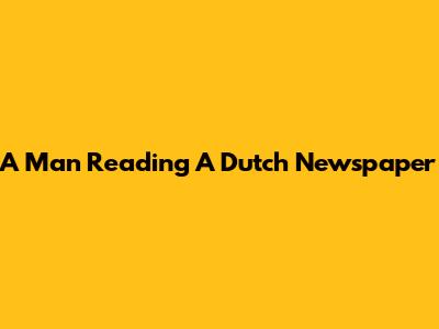 A Man Reading A Dutch Newspaper